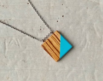 Square pendant exotic wood hand painted with turquoise geometric pattern.  Stainless steel chain