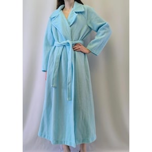 May include: A long, light blue robe with a shawl collar and a tie belt.
