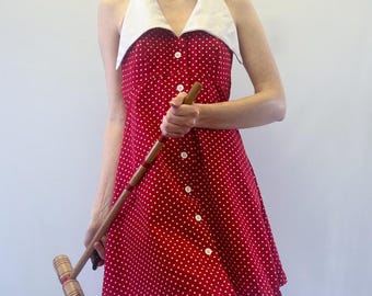 Vestido halter de lunares rojos y blancos de los años 70 con cuello exagerado y cierre de botones en la parte delantera.