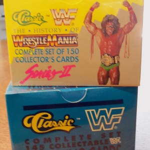 May include: Two yellow and blue boxes with the text "Classic WWF" and "The History of Wrestlemania" on them. The boxes contain a complete set of 150 collector's cards.