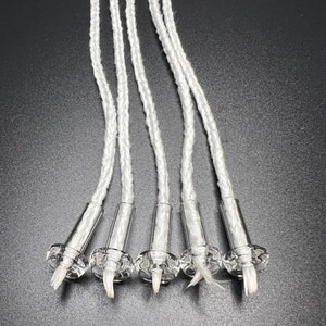 May include: Six white braided wicks with clear glass bases. The wicks are about 6 inches long and are ready to be used in a candle.
