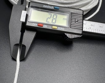 May include: Close-up of a white cotton cord being measured with a digital caliper. The caliper reads 2.8 mm.