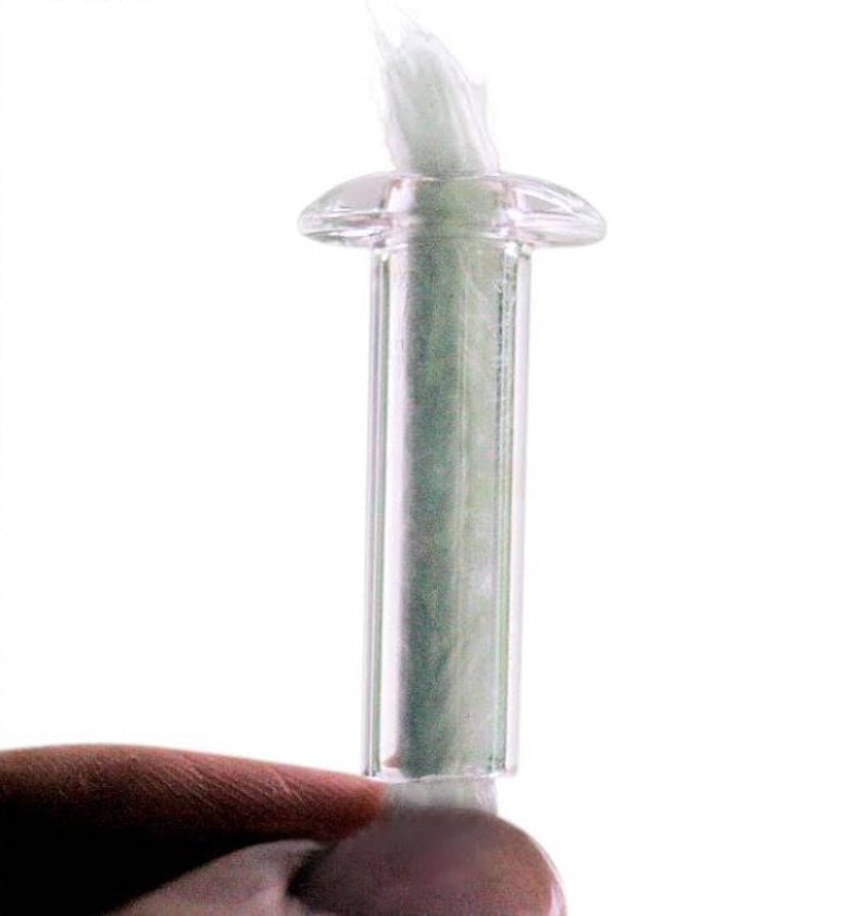 May include: A clear glass wick holder with a white wick inside. The holder has a round top and a cylindrical body.