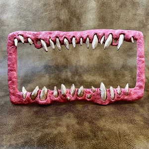 Creature teeth license plate frame anime horror Pink