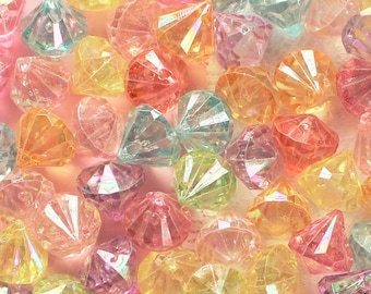 May include: A collection of iridescent plastic diamond-shaped beads in various pastel colors, including pink, blue, green, yellow, and orange.