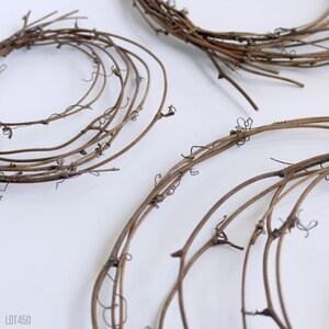 May include: Three brown grapevine wreaths of varying sizes. The wreaths are made of natural grapevine branches and are perfect for crafting.