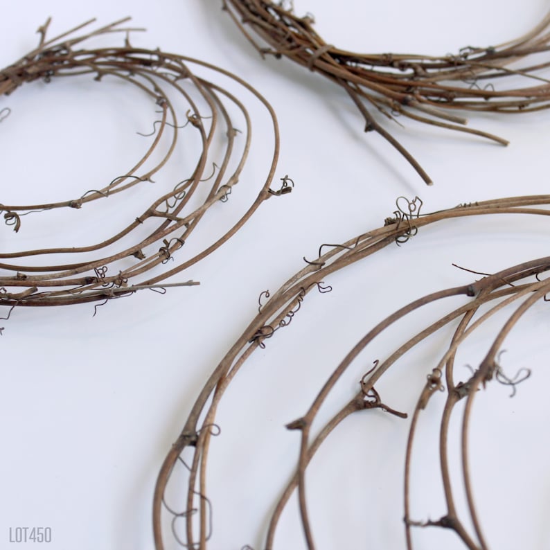 May include: Three brown grapevine wreaths of varying sizes. The wreaths are made of natural grapevine branches and are perfect for crafting.