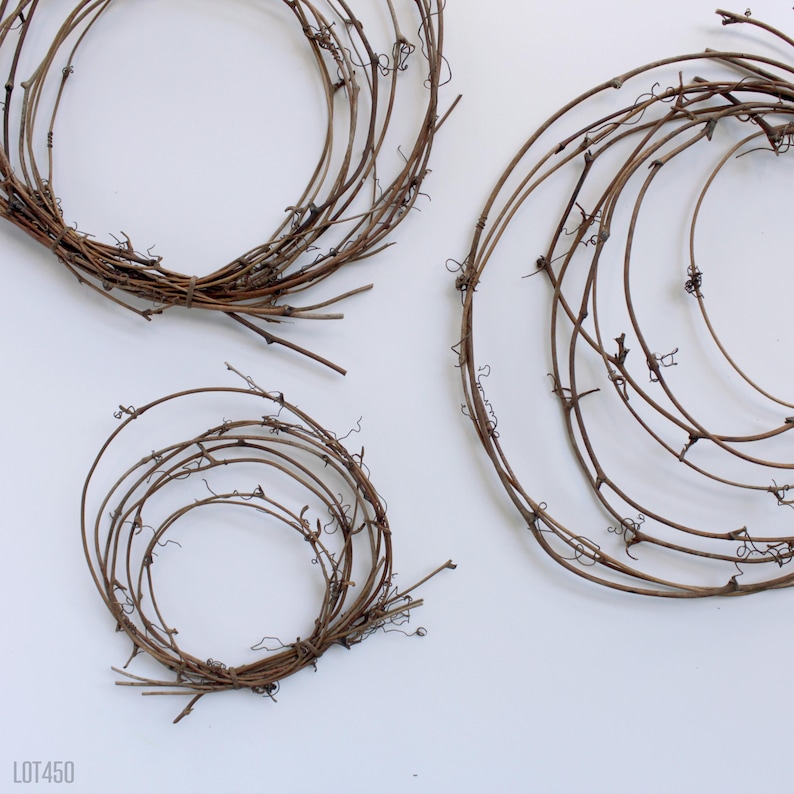 May include: Three brown grapevine wreaths of varying sizes. The wreaths are made of natural grapevine branches and are perfect for crafting.