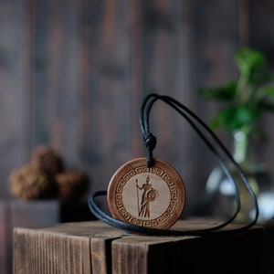 Goddess Athena Necklace/Pendant. Made from solid wood. Brown colour, round shape. Adjustable black cotton cord.