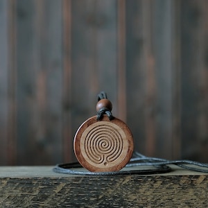 Labyrinth Necklace/Pendant. Made from solid sycamore wood. Round shape. Brown color. Adjustable cotton cord.