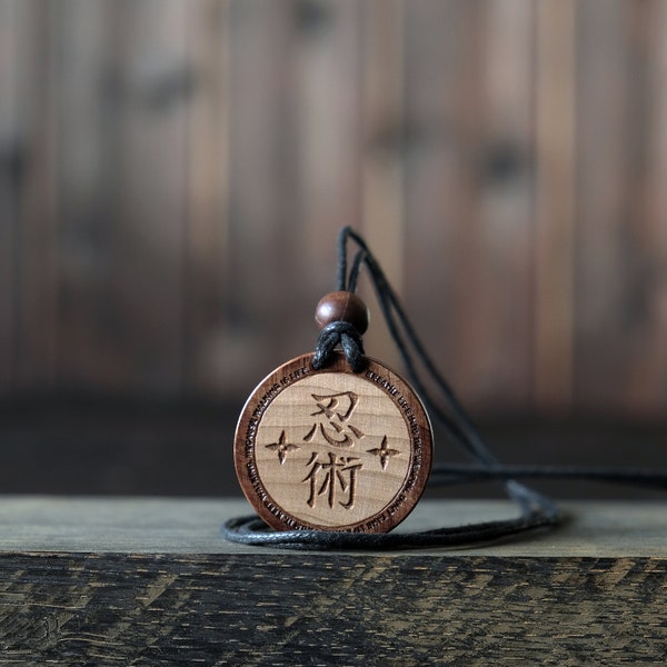 Ninjutsu Necklace/Pendant, Martial Art Necklace. Made from solid sycamore wood. Round shape. Brown color. Adjustable cotton cord.