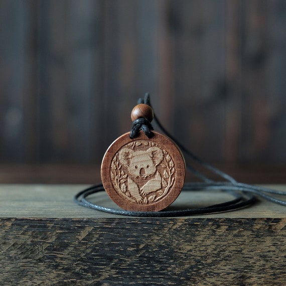 Koala Necklace/Pendant. Made from solid sycamore wood. Round shape. Brown color. Adjustable cotton cord. Text customization.