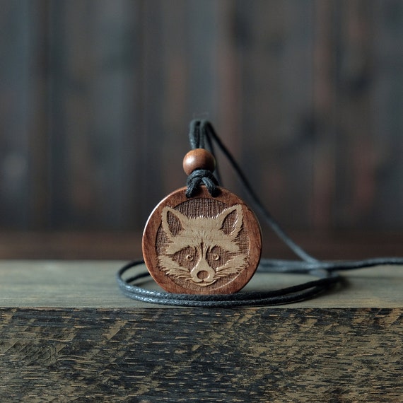 Raccoon Dog Necklace/Pendant. Made from solid sycamore wood. Round shape. Brown color. Adjustable cotton cord.