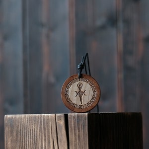 Goddess Gaia Necklace/Pendant. Made from solid wood. Brown colour, round shape. Adjustable black cotton cord.