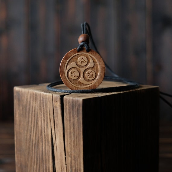 Wood Necklace-Aikido Pendant, Martial Art Necklace, Made from solid sycamore wood. Round shape. Brown color. Adjustable cotton cord.