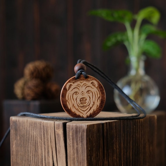 White Bear Wooden Necklace/Pendant. Made from solid sycamore wood. Round shape. Brown color. Adjustable cotton cord.