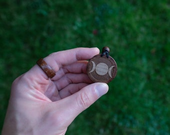Triple Moon Goddess Necklace/Pendant. Made from solid sycamore wood. Round shape. Brown color. Adjustable cotton cord. Text customization.