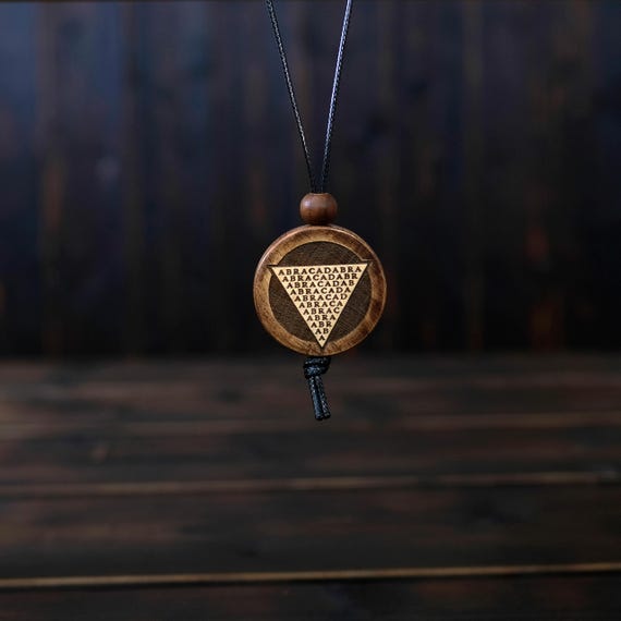 Wood Necklace-Abracadabra Necklace. Made from solid sycamore wood. Round shape. Brown colour. Adjustable cotton cord. Text customization.
