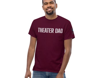 May include: A maroon t-shirt with the text "THEATER DAD" printed in white on the front.
