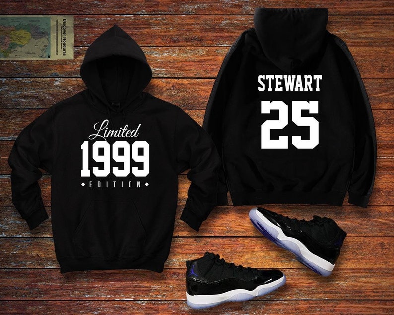 May include: Black hoodie with white text "Limited 1999 Edition" on the front and "STEWART 25" on the back. A pair of black and white trainers are also pictured.