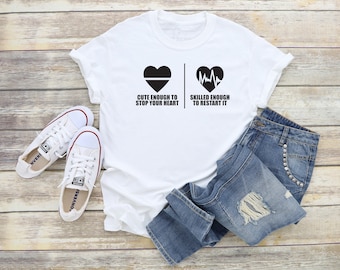 Cute enough to stop your heart - Skilled enough to restart it tshirt. cardiologist tshirt. hospital tshirt. nurse tshirt. heart. TH-082Blk