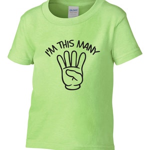 May include: A lime green short-sleeved t-shirt with black text that reads "I'm this many" and a black cartoon hand with four fingers raised.