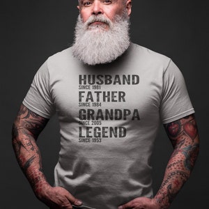 May include: A gray t-shirt with black text that reads "Husband since 1981, Father since 1984, Grandpa since 2005, Legend since 1953".