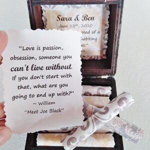 May include: A wooden box with a quote about love and a small tag with the names Sara & Ben and the date June 12th, 2020. The box is open and contains several rolled up pieces of paper.