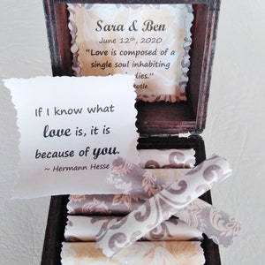 May include: A wooden box with a quote about love inside. The quote reads "If I know what love is, it is because of you." - Hermann Hesse. The box also has a small card inside with the names Sara & Ben and the date June 12th, 2020. The card also has a quote about love: "Love is composed of a single soul inhabiting two bodies." - Aristotle.