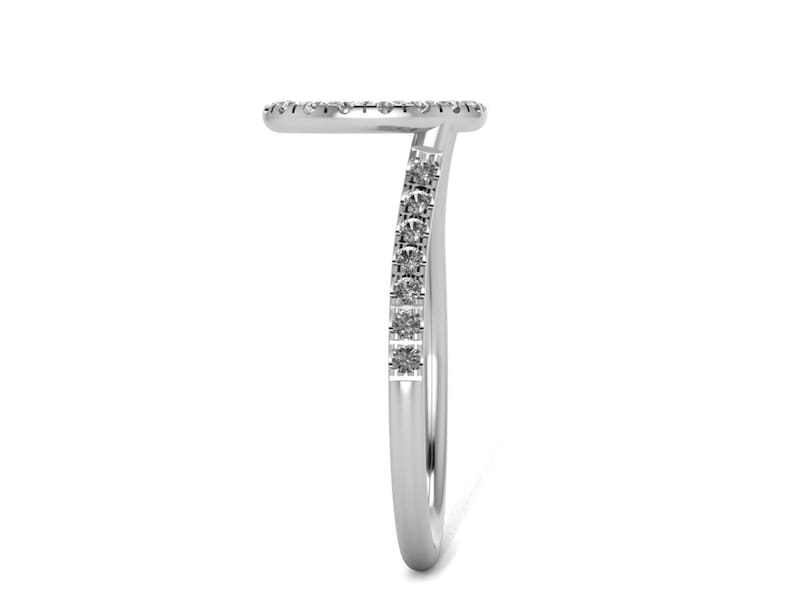 May include: A silver ring with a delicate band and a circle of small diamonds. The band is curved and the circle of diamonds is on the top of the ring.