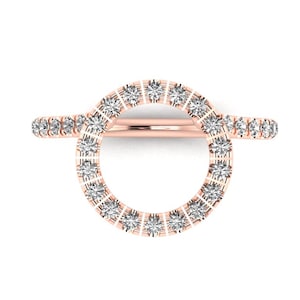May include: A rose gold ring with a circle of small diamonds. The ring is open in the back and has a delicate design.