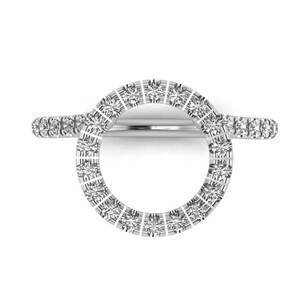 May include: A silver ring with a circle of small diamonds. The ring is designed to be worn on the finger with the circle of diamonds facing outward.