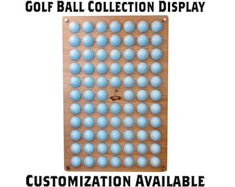 May include: A wooden golf ball display with 60 holes for storing golf balls. The display has a light wood finish and a small golf flag design in the center. The text "GOLF BALL COLLECTION DISPLAY" is at the top and "CUSTOMIZATION AVAILABLE" is at the bottom.