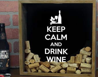 May include: A wooden shadow box with a black background and the text "Keep Calm and Drink Wine". The box is filled with wine corks.