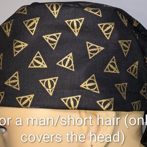 May include: Black head covering with a repeating gold triangle pattern. The triangles contain a circle and a vertical line. The text on the image says "For a man/short hair (only covers the head)".