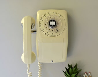 Ivory beige rotary dial side hook wall phone by Automatic Electric, restored and working