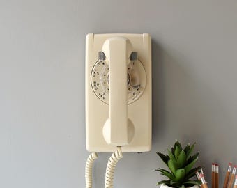 Rotary wall phone in ivory beige, restored and working