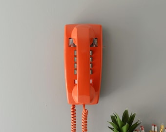 Retro touch tone wall phone in orange, restored and working