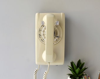 Rotary wall phone in ivory beige, restored and working