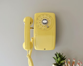 Yellow rotary dial side hook wall phone by Automatic Electric, restored and working