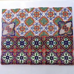 May include: A collection of colorful, square ceramic tiles with intricate floral patterns in shades of blue, green, red, yellow, and white. The tiles are arranged in a grid pattern.