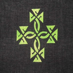 May include: A green Celtic knot cross design on a dark grey background.