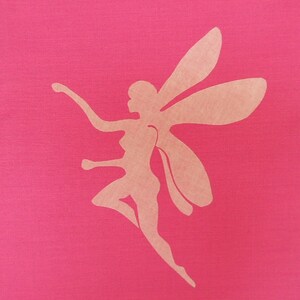 May include: A pink fabric background with a light brown silhouette of a fairy with wings.