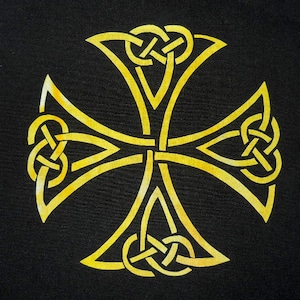May include: A gold Celtic cross with intricate knotwork designs. The cross is on a black background.