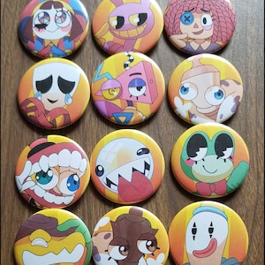 May include: A set of twelve circular pin-back buttons featuring colorful cartoon character illustrations. Each button displays a unique animated figure with distinct facial expressions, vibrant color palettes, and bold graphic outlines.