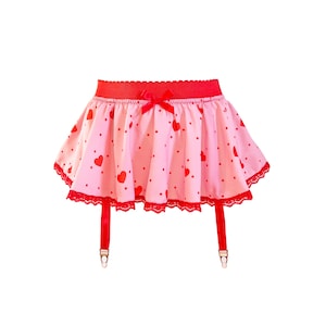 May include: A pink and red garter skirt with a heart pattern. The skirt has a red waistband, a red bow, and red lace trim. Red suspender straps with metal clasps hang from the skirt.