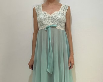 May include: A light blue sheer nightgown with a white lace bodice and a matching ribbon tie at the waist.