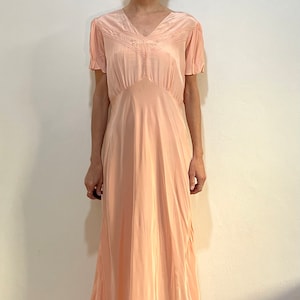 Abito sottoveste in rayon rosa dal taglio sbieco anni ’30 con pieghe spillate cucite a mano e ricami floreali