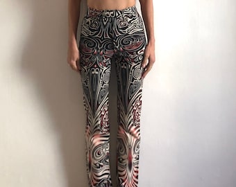 May include: A two-piece outfit featuring a red crop top with a black and white print and black and white patterned pants with red accents.