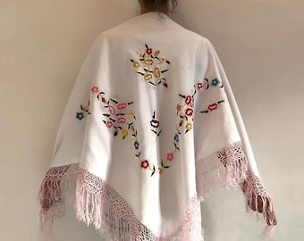 May include: White shawl with pink fringe and colorful floral embroidery.